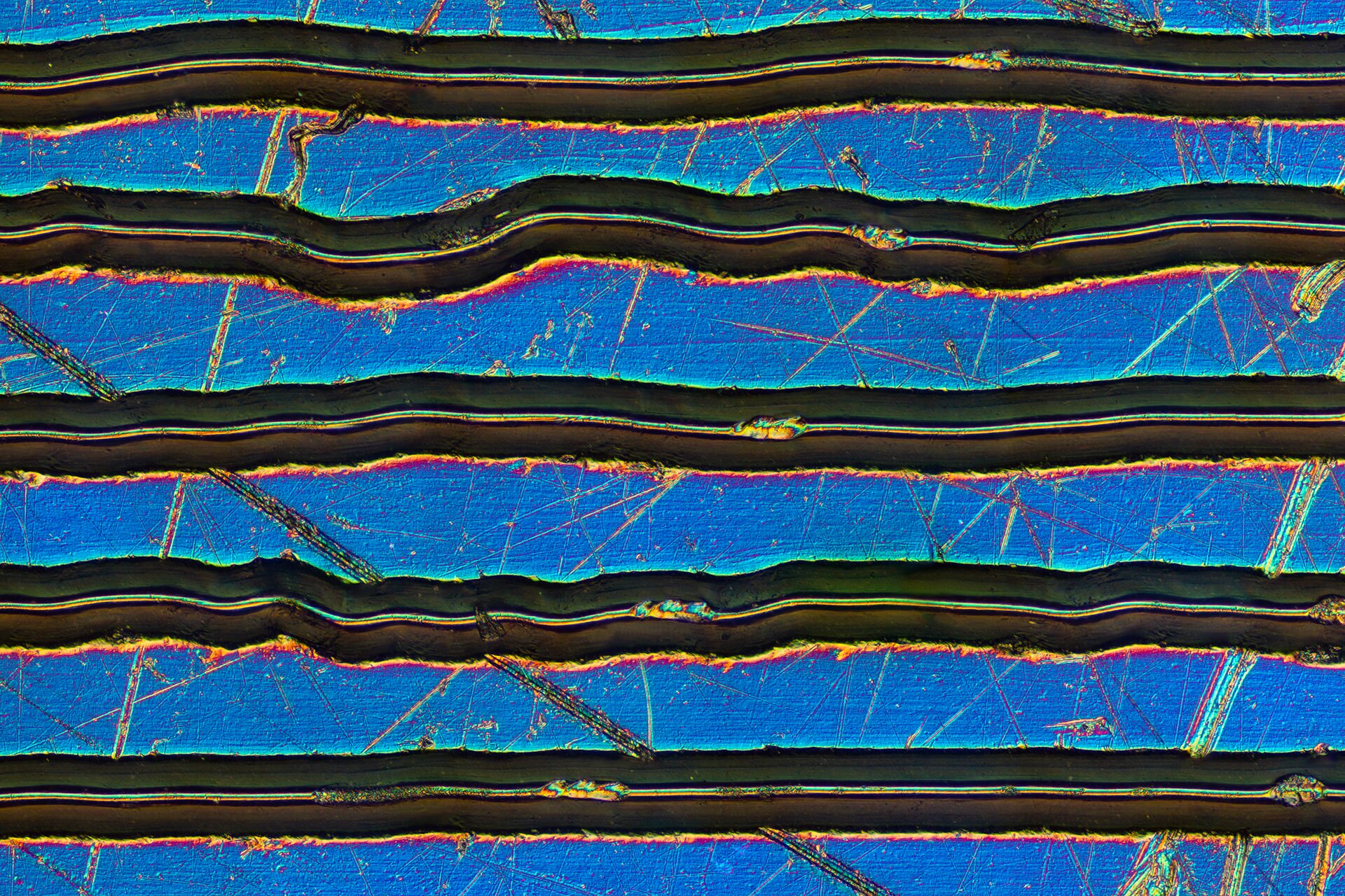 Magnified scratch on a record surface under a microscope