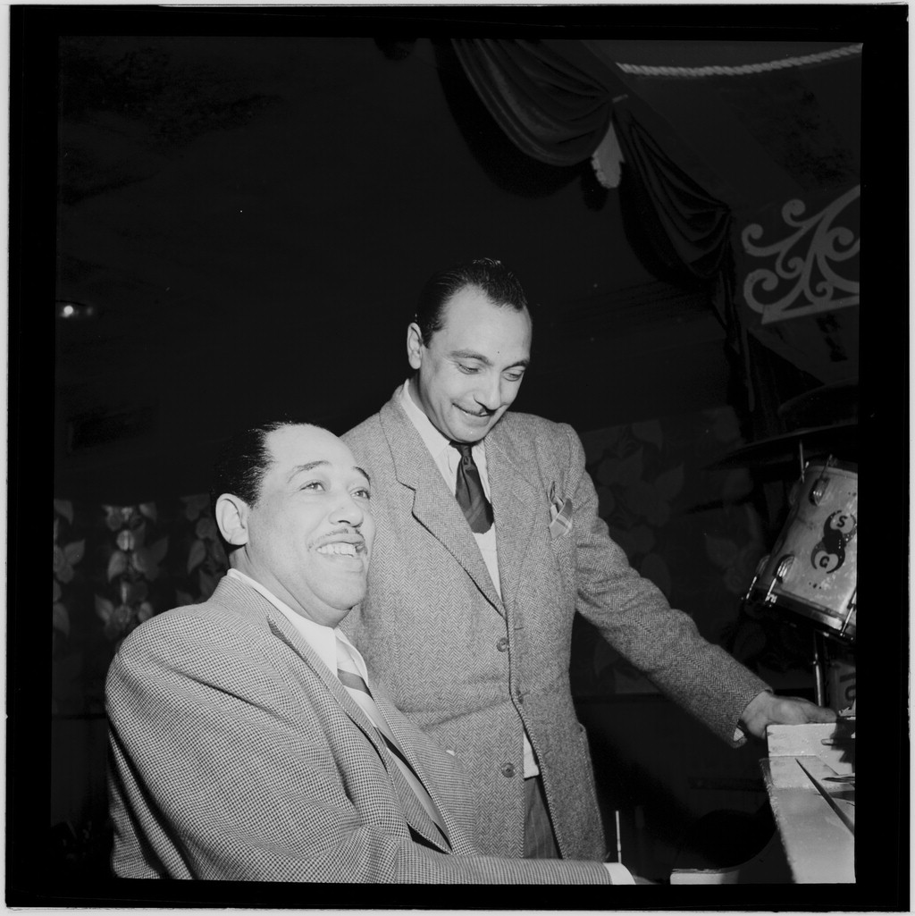 The Aquarium club, New York, 1946: Duke Ellington (seated) with guitarist Django Reinhardt. Reinhardt was the heart of the Quintette du Hot Club de France, and Panassié and Delaunay ran that club. William P. Gottlieb, who took several of the 1940s photos in this article, was himself a jazz critic writing for *The Washington Post* and *Down Beat*. Library of Congress, public domain.
